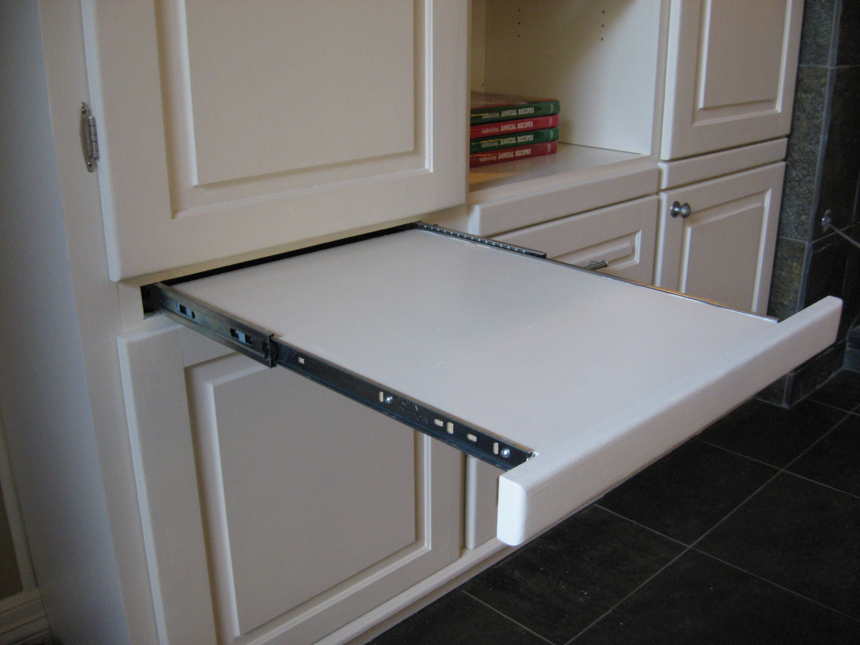 A pullout shelf under the A/V Rack allows for quick connection of the